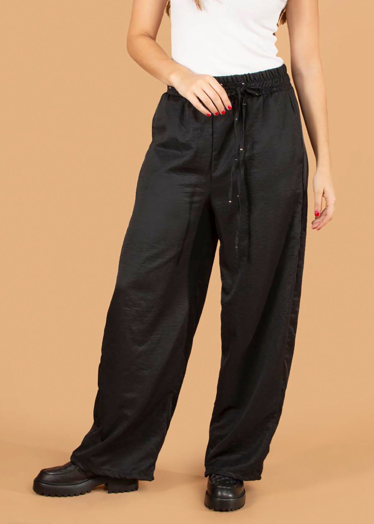 Pantalón color negro con resorte en cintura y taches 104415