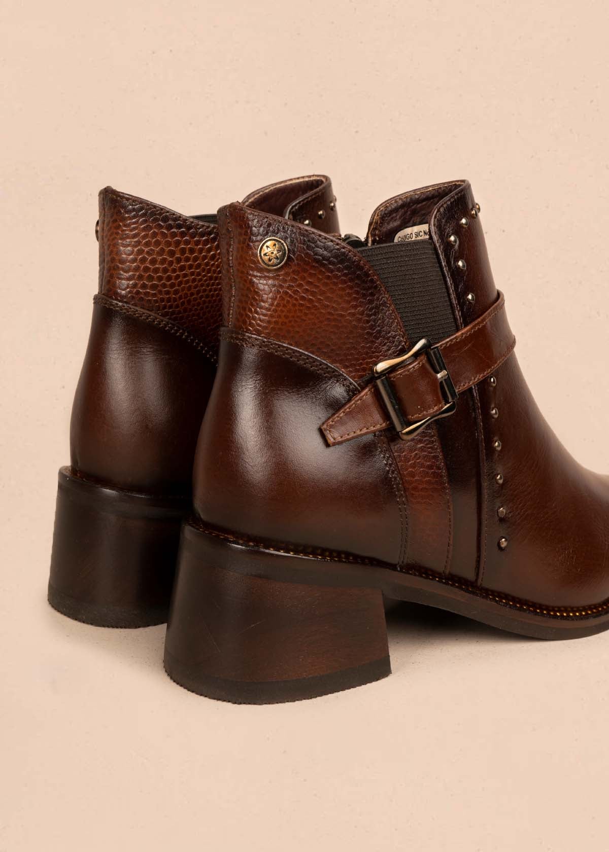 Botín en cuero color café con taches en los laterales y hebilla decorativa 105953