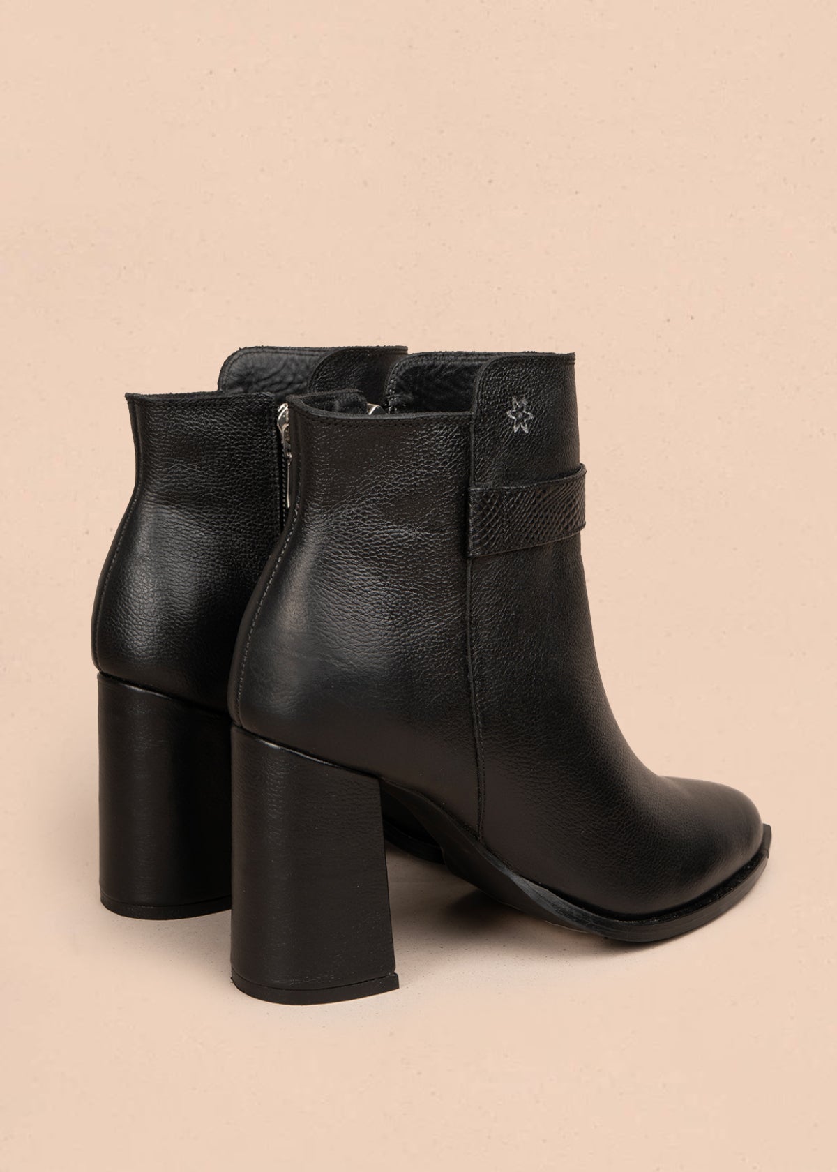 Botín en cuero color negro con correa decorativa y acabado liso 106109