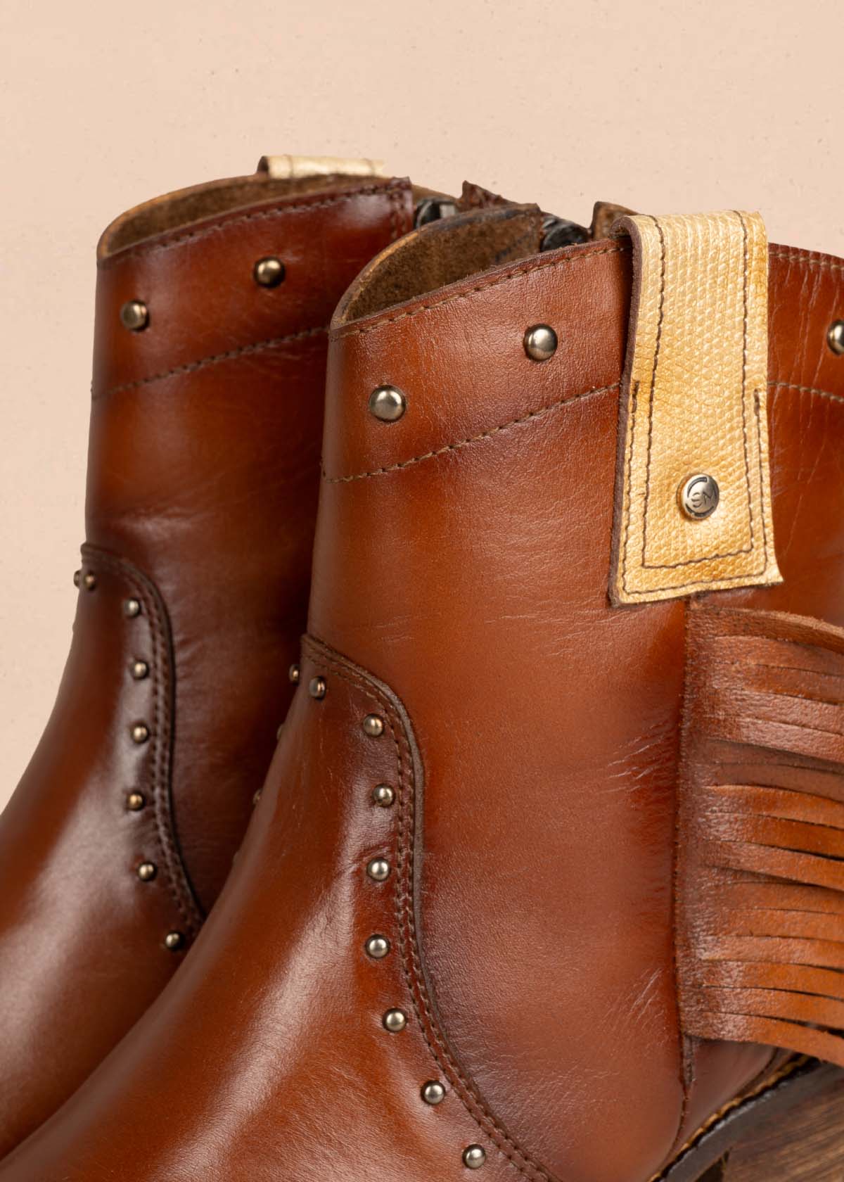 Botines en cuero color miel con taches y flecos 105273