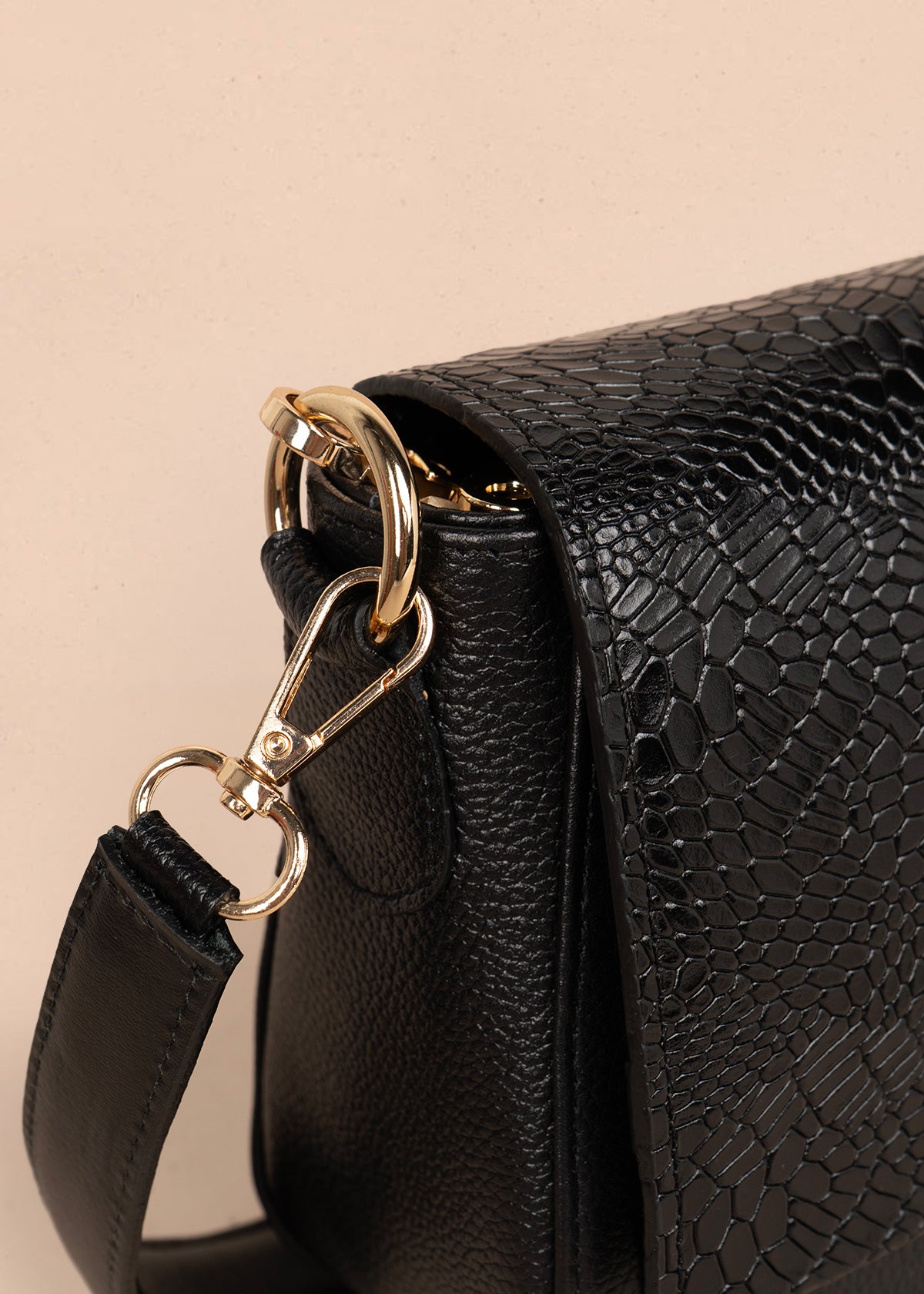 Bolso manos libres en cuero color negro con solapa textura croco 105792