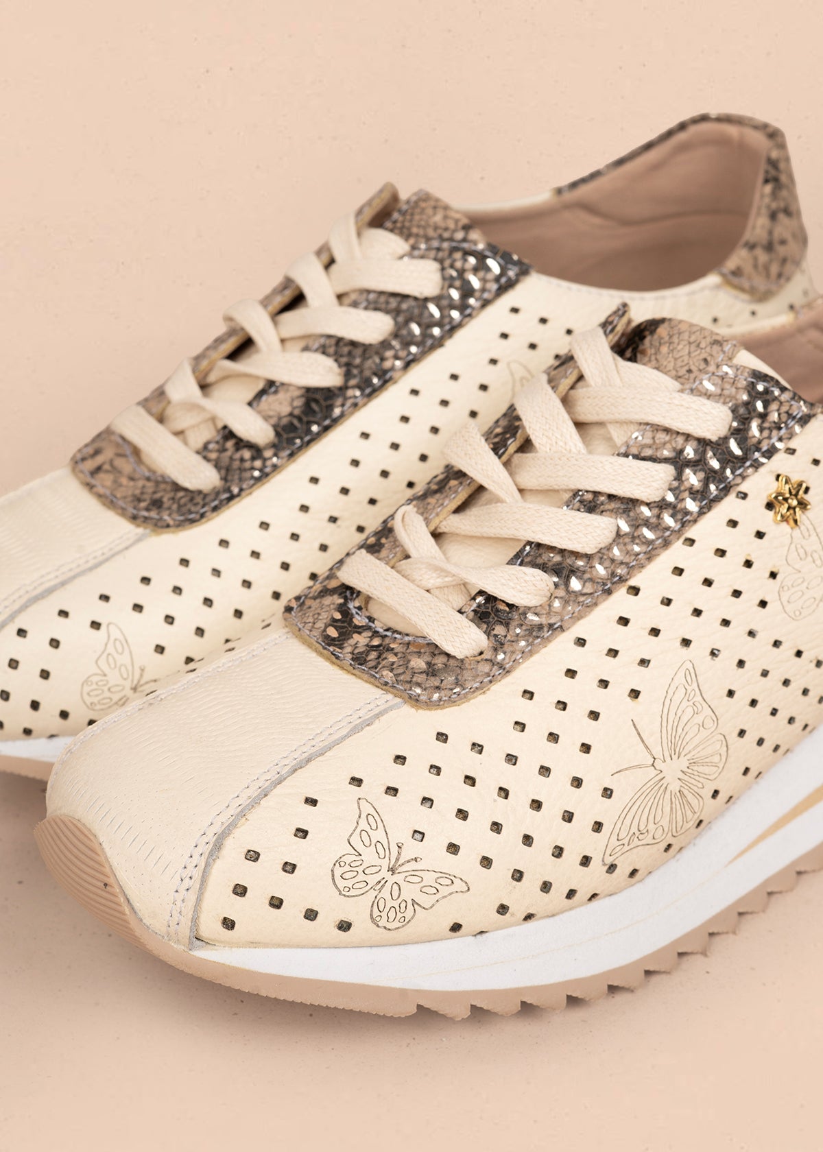 Tenis casuales en cuero color talco con perforaciones y grabado de mariposas 106079