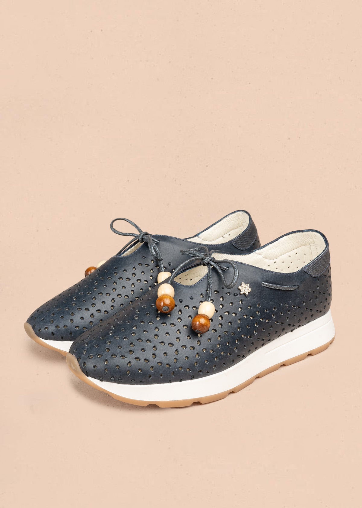 Atadura en cuero color azul con calados en gota y cordón de madera 106935